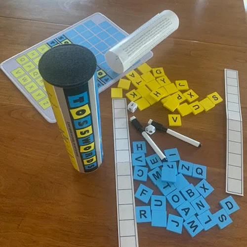 Word game components on a wooden table.