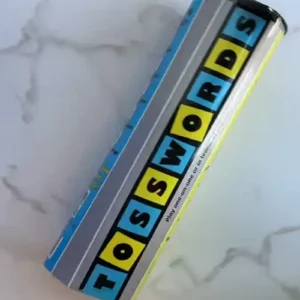 Tosswords game box on marble surface.